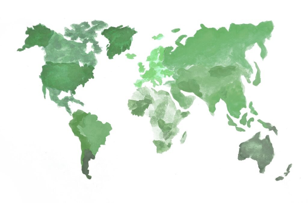 The world map is made with camouflage watercolor paints on white paper